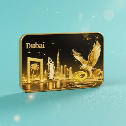 Personalized UV Printed Rounded Rectangle Magnet featuring a stunning gold foil skyline of Dubai, including the iconic Museum of the Future, the Dubai Frame, the Burj Al Arab, the Burj Khalifa, and a powerful golden falcon flying prominently on the right. The magnet is set against a vibrant teal background.