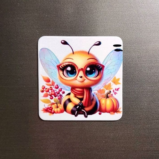 Personalized 6.5cm rounded square custom magnet with a cute bee design, showcased against a metallic background.